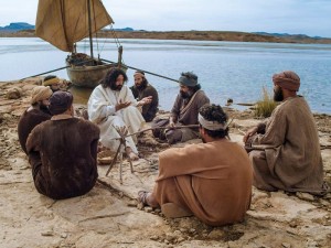 Photo of Jesus and disciples sitting by a boat.